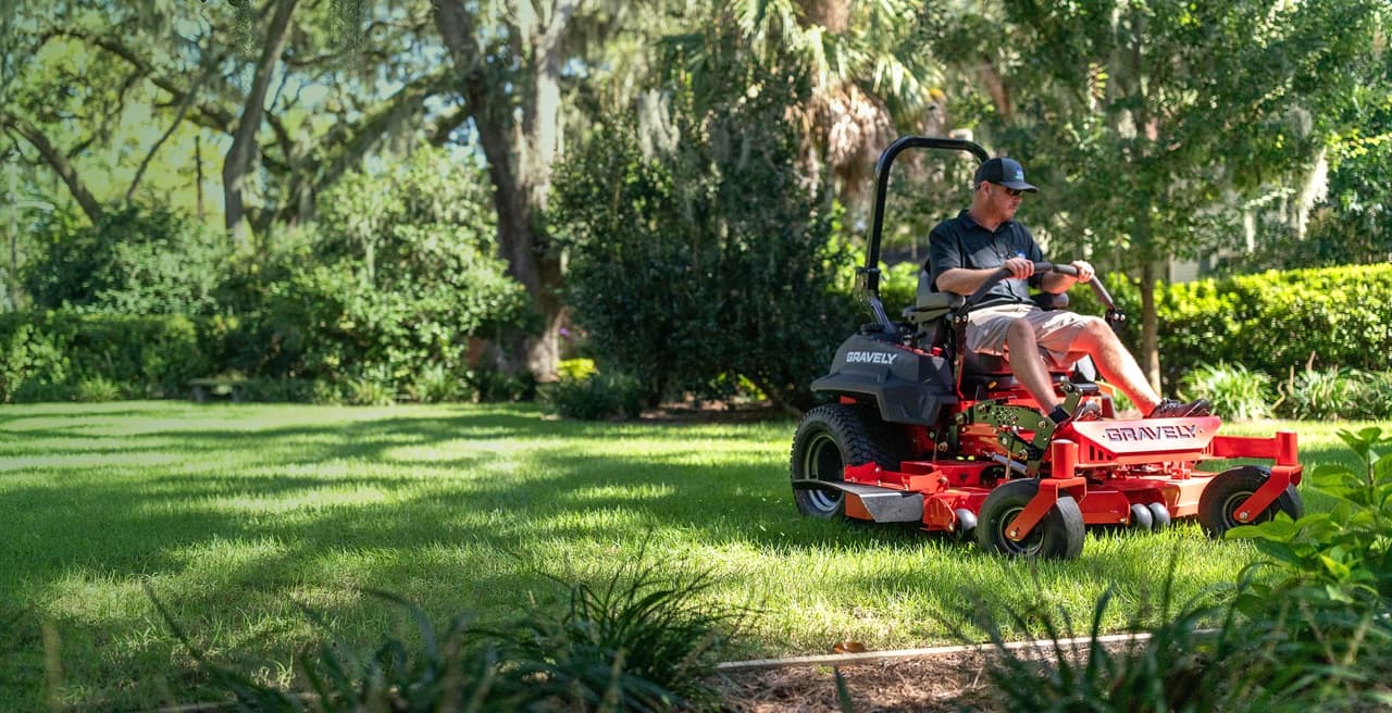 Lawn care professional operating a commercial Gravely mower